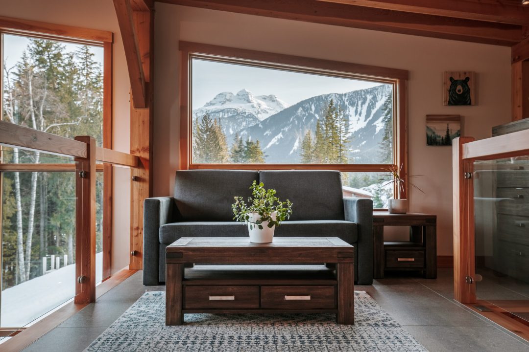 Large windows in Pillows Lodge living room with stunning Revelstoke mountain views